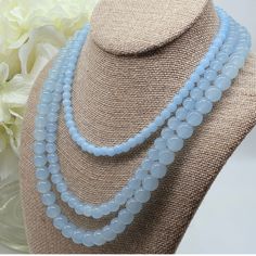 Indulge in the timeless elegance of the Amicae Blue Single Strand Necklace - a handcrafted crystal glass masterpiece that exudes sophistication with every single strand - The icy blue hue of the beads brings images of clear winter skies. In contrast, the single-strand design adds a touch of simplicity to this work. Whether you're attending your best friend's wedding or dressing for an important business meeting, the Amicae Blue Necklace will surely be your go-to accessory for that perfect finish Elegant Blue Faceted Beads, Light Blue Single Strand Necklace With Round Beads, Light Blue Round Beads Necklace For Gifts, Light Blue Polished Beads Necklace For Gift, Elegant Blue Necklace With 8mm Beads, Elegant Blue Necklaces With 8mm Beads, Elegant Blue Necklace With Round Beads, Light Blue Gemstone Beads Necklace For Gift, Light Blue Faceted Beads Elegant Jewelry