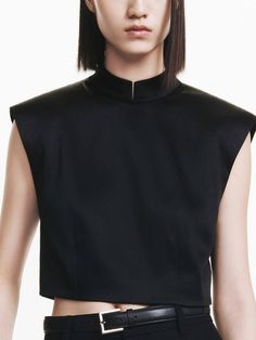 MO&Co. Women's Back Zip Cropped Top Introducing our top - made with luxurious satin and soft touch material for comfortable and stylish wear. Its cropped cut and v-neckline at the back with zipper add a unique touch, while the wide shoulder design provides a flattering fit. Perfectly paired with pants for a chic look. Features : - Cropped and wide shoulder- Stand collar with a metallic bead closure- V-neckline at the back with zipper- Satin and soft touch Code: MBD3TOP025The back length of size Chic Cropped Blouse For Formal Occasions, Chic Crop Top Blouse For Evening, Chic Evening Crop Top Blouse, Chic Satin Crop Top For Evening, Sleek Satin Top For Evening, Cropped Padded Blouse Crop Top For Party, Silk Cropped Crop Top For Party, Cropped Top For Evening, Elegant Crop Top Blouse For Workwear