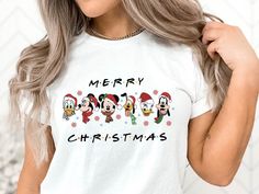 Merry Christmas Tee, Disneyworld Friends Mickey And Minnie Tshirt Gift, Christmas Shirts For Best Friends, Holiday Shirt, Friends Xmas Gift Welcome to CrystalThreadsUS. You are at the address where you can find special and beautiful products that suit your style. Take a look at our wide collection that we have carefully selected for you and discover your favorite piece. We wish you pleasant shopping! PRODUCTS Tees are Unisex, classic fit. Please refer to size chart in listing photos for details.  For printing, we use Bella Canvas and Gildan SoftStyle brand shirts, which are the best in the industry. *Bella Canvas -unisex size -4.2 oz. -Solid colors are 100% Combed Cotton and Ring-Spun Cotton. -Athletic Heather 90% Combed and Ring-Spun Cotton, 10% Polyester -All Heather CVC Colors 52% Combe Disney Graphic Print T-shirt For Holiday, White Christmas T-shirt With Character Print, Disney Christmas Holiday Tops, White Christmas Character Print T-shirt, Christmas Disney Holiday Top, Disney Christmas Holiday Top, Disney Christmas Cotton Top, Disney Holiday Crew Neck T-shirt, Disney Cotton Christmas Tops