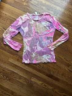 This 70's  vintage novelty shirt is long sleeve in pink purple and tan abstract splotches.  It has dancing women in the pattern. It is light weight.  It is in decent condition.  The hems are a little rolled as shown in pictures. Chest-33 inches with no pull Waist-26 inches Bottom hem-30 inches Sleeve-22.5 inches Shoulder seam to shoulder seam- 15 inches Length from shoulder to hem-22 inches To see more of our authentic 1970's clothing inventory please visit our store at ChoiceRecycling.  We add new items every week. Thank you, Karmyn Purple Long Sleeve Top, 1970s Clothing, Novelty Shirts, Purple Long Sleeve, Womens Blouses, Pink And Purple, Womens Clothing Tops, Long Sleeve Top, Pink Purple