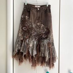 Rossi Roma Brown Denim Layered Ruffle Sequin Midi Skirt. Embroidered Flowers And Paisleys With Sequin Detailing. Raw Hem Lace Ruffle. Some Wear To The Lace/ Ruffle Bottom But Otherwise And Great Condition. Size Small **Matching Denim Top Available** Material: 76% Cotton, 14% Nylon, 10% Elastane Waist: 27 Inches Approx Length: 30.75 Inches Approx Tags Y2k Vintage Rare Coquettegirl Romantic 90s Maximalism Lace Layered Skirt Edgy Fall Autumn Jean Skirt Free People Like Anthropologie Like Urban Outf Jean Skirt With Lace, 90s Maximalism, Tattered Skirt, Tool Skirt, Patch Skirt, Rag Skirt, Sequin Maxi Skirt, Dolly Christmas, Maxi Sequin Skirt