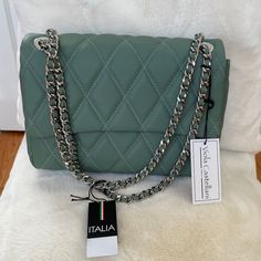 -Quilted, Dual Compartment Design, Sliding Crossbody Strap -12in W X 9in H -43in Strap, Fully Extended -Push Lock Closure -2 Interior Slip Pockets, 1 Interior Zip Pocket, 1 Organizational Zip Pocket -Lleather -Made In Italy Elegant Quilted Evening Bags, Luxury Green Quilted Bag, Luxury Quilted Pouch Bag, Designer Green Shoulder Bag With Chain Strap, Luxury Green Clutch For Shopping, Chic Quilted Evening Clutch, Luxury Quilted Clutch Shoulder Bag, Chic Green Shoulder Bag With Magnetic Closure, Chic Quilted Clutch Bag