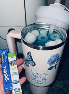 a person holding a cup with toothpaste in it