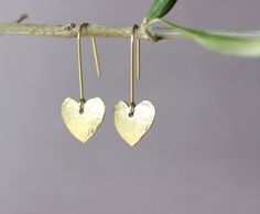 "You will receive one pair of brass earrings from my brass jewelry collection. You can see the whole collection here: https://www.etsy.com/shop/ARTISUNtis?ref=seller-platform-mcnav§ion_id=42470765 * Heart earrings with tiny textured heart/15 mm/ * hammered earrings - hammered by hand for texture and unique pattern design * lightweight earrings - it is a pleasure to wear them * minimalist earrings - simple, but elegant design * everyday earrings and for special occasions * Perfect gift - suitable for gift to you or to the special one in your life * including \"care instructions\" * raw brass ear wire hook earrings About material: Brass is a sturdy metal - combination of zinc and copper.  For that reason will naturally tarnish when exposed to oxygen.  Often used in fashion jewelry, brass doe Nickel Free Gold Brass Heart Earrings, Nickel-free Gold Heart Earrings In Brass, Nickel-free Gold Heart Brass Earrings, Nickel-free Gold Brass Heart Earrings, Everyday Gold Heart Earrings With Ear Wire, Heart Charm Brass Earrings As Gift, Brass Heart Charm Earrings For Gifts, Brass Heart Charm Earrings As Gift, Handmade Brass Heart Dangle Earrings