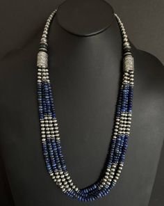 This beautiful multi-strand necklace features genuine lapis and sterling silver pearls beads, strung on a sturdy sterling silver chain. The necklace measures 30 inches in length and is perfect for adding a touch of Southwestern style to any outfit. The combination of the deep blue lapis and the oxidized pearls creates a stunning contrast that is sure to turn heads. The necklace is of high-quality .925 sterling silver and is suitable for daily wear. The beaded design gives it a unique look that i Cheap Silver Multi-strand Beaded Necklaces, Silver Hand-strung Multi-strand Necklaces, Elegant Silver Beaded Lapis Lazuli Necklace, Silver Multi-strand Gemstone Beads, Silver Multi-strand Beaded Necklace With Gemstone Beads, Silver Multi-strand Beaded Necklaces With Gemstone Beads, Silver Multi-strand Beaded Necklaces With Natural Stones, Silver Gemstone Beads In Multi-strand, Traditional Silver Lapis Lazuli Necklace