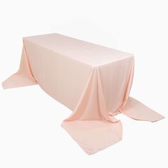 a pink table cloth on top of a white table