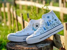 🌸 Hand-Embroidered Floral Converse Wedding Shoes - Perfect for Brides and Bridesmaids.  Are you looking for the perfect blend of comfort and style for your wedding day? Our hand-embroidered floral Converse wedding shoes are the ideal choice for brides and bridesmaids who want to add a unique touch to their special day. Each pair is meticulously crafted with love, featuring beautiful floral embroidery that makes every step down the aisle unforgettable. 📌Key Features: Material: High-quality canvas with hand-embroidered floral designs Sizes: Available in all standard sizes Colors: Classic white Converse with multicolored floral patterns Style: Low-top and high-top options available Why You'll Love These Shoes: Unique Design: Each pair is one-of-a-kind, with intricate floral embroidery that Embroidered Converse High Tops, Floral Converse, Converse Wedding, Converse Wedding Shoes, Embroidered Sneakers, Thoughtful Wedding Gifts, Embroidered Converse, Wedding Converse, Shoes Unique