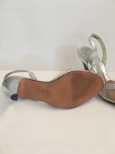 "Vintage clear lucite, leather and silver rhinestone high heels with lots of sparkle! These shoes were well cared for and came in their original box. A well made quality shoe by Amano Bootier. Like new condition, with no scuffs or marks, possibly worn once! label: Amano Bootier Silver Gala fabric: leather, lucite, rhinestones size: labeled size is 7 1/2 M. Please check measurements for an accurate fit. Questions are welcome! interior heel to toe - 9 3/8\" widest part of foot - 2 3/4\" heel heigh Shiny Open Toe Heels For Formal Occasions, Formal Shiny Open Toe Heels, Silver Vintage Heels For Party, Formal Clear Heels With Rhinestones, Vintage Silver Heels For Evening, Rhinestone High Heels For Anniversary, Anniversary High Heels With Rhinestones, Anniversary Rhinestone High Heels, Silver High Heels For Anniversary