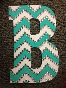 the letter b is made out of paper and beaded with sequins on it