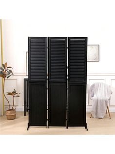 the room divider is black and has four doors