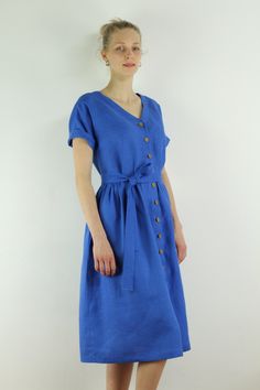 "Spring dress, Write the selected color in the message Handmade indigo color linen dress with short sleeves and 2 pockets , perfect for casual wear and suitable for any occasion in any season Details: - 100% natural linen produced in Europe ; - medium weight (180 gram per square meter); - color:indigo linen, could be any from our colors catalog (color samples at the photo); Made to order, approximately a few days, If you have any questions please message me and I will be glad to answer. Size gui Summer Indigo Dresses With Buttons, Casual Blue Linen Dress, V-neck Linen Dress With Pockets, Short Sleeve Midi Dress With Pockets For Vacation, Blue Relaxed Fit Linen Summer Dress, Summer Dresses With Short Sleeves And Buttons, Casual Blue Linen Midi Dress, Blue Short Sleeve Dress With Pockets, Blue Short Sleeve Dresses With Buttons