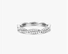 14K White Gold Petite Infinity Diamond Ring. The infinity design is a timeless classic perfect for everyday wear. Crafted in 14K gold, this piece is beautiful worn on its own or with other stackables for a trendier look. Classic Diamond Cut Eternity Band, White Classic Eternity Band, Modern Twist White Diamond Ring, Elegant Stackable Eternity Band, Modern Twist Infinity Stackable Rings, White Gold Diamond Cut Band, Elegant White Stackable Diamond Ring, Elegant White Gold Stackable Rings, Classic White Gold Infinity Jewelry