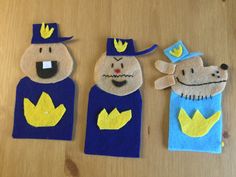 three felt puppets made to look like people with hats and tails, one wearing a crown