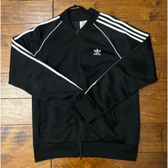 Adidas 3 Stripe Essentials Tricot Jacket Size - Large In Brand New Condition Worn Only A Few Times Adidas Long Sleeve Outerwear With Three Stripes, Black Outerwear With Three Stripes For Fall, Adidas Three Stripes Fall Outerwear, Adidas Black Outerwear With Three Stripes Branding, Adidas Outerwear With Three Stripes For Fall, Winter Black Outerwear With Three Stripes, Classic White Long Sleeve Track Jacket, Classic Fitted Winter Track Jacket, Fitted Three Stripes Outerwear For Fall