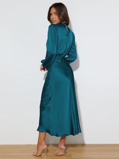 Make a statement in this FROM THE SOURCE High Neck Bridal Maxi Dress in an elegant teal! This stunning satin dress will make waves as you walk down the aisle and beyond. Dare to be bold and defy expectations with this daring wedding guest style dress. Stand out! Size Guide: Model is 5’7” tall, and has a 33.4” bust, 26.5” waist, & 34.6” hips. She is wearing a S / US 4 / AU 8. This dress is true to size. Material: 100% Polyester. Feature: High Neckline. Long Sleeve. Flowery Skirt. Elastic Waist. Maxi Length. Care Instructions: Machine wash / Cold hand wash Wedding Midi Dress With Satin Finish, Elegant Turquoise Maxi Dress For Party, Elegant Turquoise V-neck Maxi Dress, Elegant Turquoise Party Maxi Dress, Elegant Fitted Turquoise Maxi Dress, Satin Midi Dress For Wedding, Solid Satin Midi Dress For Wedding, Long Sleeve Turquoise Dresses For Wedding, Elegant Turquoise Maxi Dress