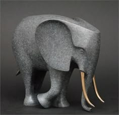 an elephant made out of concrete with long tusks