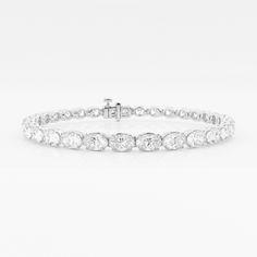 Elegant and yet unique, oval shaped diamonds are stylishly set in an east-west pattern in this beautiful tennis bracelet. Lab grown diamonds, as unique as you, glisten through this gorgeous setting, making the light dance to your tunes. Luxury Oval Diamond White Diamond Bracelet, Luxury Diamond White Oval Diamond Bracelet, Luxury Oval Diamond Tennis Bracelet, Luxury Oval Diamond Cut Tennis Bracelet, Luxury Oval Tennis Bracelet With Single Cut Diamonds, Timeless Oval Diamond Bracelet, Luxury Oval Diamond Bracelet With Prong Setting, Luxury Oval Tennis Bracelet With Diamond Accents, Luxury Oval Diamond White Bracelets