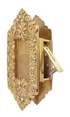 an ornate gold door handle with a key in it