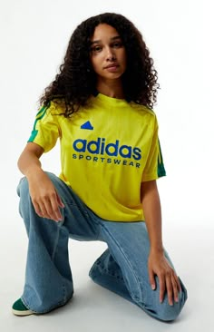 Stay sporty in the Yellow Tiro T-Shirt from adidas. This jersey-style tee features a classic crew neckline, short sleeves, and tonal stripes, complete with contrast 3-Stripes on the shoulders. The soft-touch rubberized adidas logo graphic adds a sleek finish, while the relaxed fit ensures comfort on and off the field.Tonal stripe jerseyShort sleevesCrew necklineadidas soft-touch rubberized graphic3-StripesRelaxed fit100% recycled polyester; Rib: 96% recycled polyester, 4% spandexMachine washableModel is wearing a size smallModel measurements: 5’10” height, 32” bust, 24” waist, 35” hipsLearn more about PacSun eco items adidas Womens Yellow Tiro T-Shirt size Small Yellow Sporty Outfit, Graphic Tees Pacsun, Thrift List, Adidas Yellow, Rose Tyler, Adidas Womens, Jersey Style, Yellow T Shirt, Adidas Sportswear