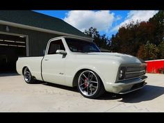 a white truck parked in front of a garage