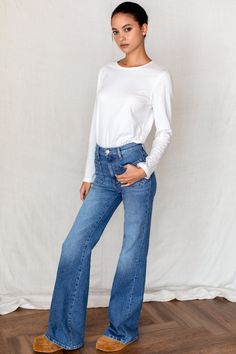 The Treasure Bell jean puts a new twist on an iconic 1970's silhouette made modern through fit and fabric, offered in a premium Italian stretch denim. This high rise retro inspired fit sits high at the waist, slim through the hip and straight with an elongating bell-shaped leg. has two topstitched front pockets. The magical back rise, yoke seams and signature back pockets are shaped to be a focal point in this fit, creating the perfect "backseat" on anyone. It’s a perfect wear everywhere with an Fall High-rise Denim Flare Jeans, Fall High Rise Denim Flare Jeans, High Rise Denim Flare Jeans For Fall, High Rise Flare Jeans For Fall, Chic Relaxed Fit Dark Wash Flare Jeans, Chic Dark Wash Relaxed Fit Flare Jeans, Chic Dark Wash Flare Jeans For Everyday, Fall High-waist Medium Wash Flare Jeans, Fall Standard Cut Denim Flare Jeans