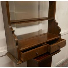 an antique wooden desk with drawers and shelves