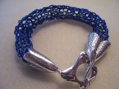 a blue bracelet with silver clasps on it