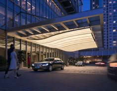 two cars parked in front of a building at night