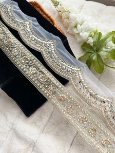 Gold Embellishment with curved mirror & faux pearls perfect for designer clothing, Mirror work lace trim Vine, Bridal dress embellishment. This beautiful lace trim is great for any sewing and craft projects. A perfect match for bridal dresses or any festive occasions. Our lace will add charm to your fabric, you can use this lace alone or add it with other laces to create a new unique design for, any of your project : Sold per 9.5 Yard  length, you can increase the length in multiples of 1 meter Elegant Embroidered Fabric With Border For Parties, Elegant Festive Trims With Embroidered Border, Elegant Trims With Embroidered Border For Party, Elegant Party Trims With Embroidered Border, Elegant Embroidered Border Trims For Party, Elegant Embroidered Border Trims For Festive Occasions, Elegant Embroidered Organza Fabric With Border, Elegant Organza Fabric With Embroidered Border, Elegant Embroidered Party Trims