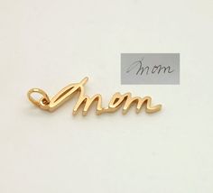 This is a listing for a 14K gold personalized custom charm.Charms are small and generally contain one word/name/signature, approximate size is 0.6-1 inch without clasp.If you need a bigger pendant, please check this listing:https://www.etsy.com/listing/489952651/sympathy-gift-memorial-signature-jewelryThere are different fixtures available how to attach your charm to the bracelet/chain:- Simple loop.Charm will be put on a simple loop that you put a chain through, it fits majority of necklaces, b Elegant Personalized Charms As A Gift For Mom, Personalized 14k Gold Charms, Elegant Charms For Anniversary And Mother's Day, 14k Gold Personalized Signature Jewelry, Gold Elegant Charms For Mother's Day, Elegant Gold Charms For Mother's Day, Signature Yellow Gold Jewelry For Anniversary, Personalized 14k Yellow Gold Charms, Personalized White Gold Charms For Mother's Day