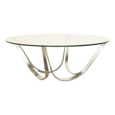 an oval glass table with metal legs and a curved design on the top, against a white background