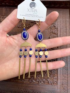 This listing is for long, dramatic, royal blue and gold chandelier earrings featuring vintage style etched beads, 4mm Lapis Lazuli stone beads, gold plated chain, and raw brass beads.Lapis Lazuli is known as the wisdom stone. It is thought to bring peace and harmony and encourage self-awareness and self-expression.These earrings hang approximately 4.0" inches from the lobe and measure about 0.75" inches across their widest point. The lever back closures are 22k gold plated and should be suitable