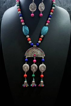 Dramatic, colorful oxidized silver Indian peacock necklace, with bead jhumka. The large central medallion is in the shape of an open peacock tail with a sparkly crystal border. Variety of bead shapes and sizes add visual interest. Perfect for tropical beach vacation as it is fun, lightweight and goes with all colors in your wardrobe. This is a very attractive necklace! You are certain to get many compliments! Necklace is 9.5 cm. Lobster claw clasp. Pendant measures 5 in x 3 in. including the dan Multicolor Oxidized Jewelry As Gift, Multicolor Oxidized Finish Jewelry As Gift, Multicolor Temple Jewelry Pendant Set, Bohemian Silver Jewelry Sets For Celebration, Multicolor Peacock Temple Jewelry, Multicolor Peacock Design Temple Jewelry, Fusion Style Silver Beads Jewelry For Festivals, Multicolor Necklace With Oxidized Finish For Gift, Handmade Jewelry With Round Beads For Navratri