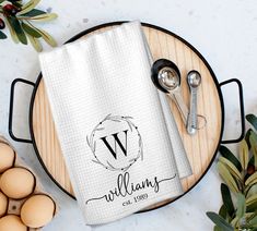 a dish towel with the letter w on it next to eggs and utensils