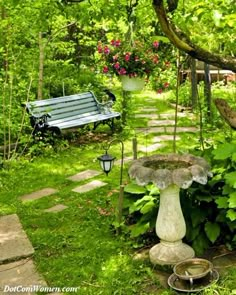 a bench sitting in the middle of a lush green park