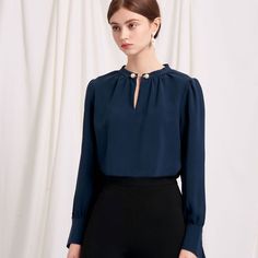 Everyone's favourite modern vintage style Buvette Pearl blouse now updated in a midnight-blue hue, featuring gently puffed sleeves, french cuffs and our signature pearl embellishment at the collar. Wear yours with a neutral coloured bottom and a bold red lip. Blue Blouse For Semi-formal Fall Occasions, Blue Blouse For Semi-formal Fall Events, Semi-formal Blue Blouse For Fall, Blue Blouse With Balloon Sleeves For Work, Office Blouse With Blouson Sleeves, Elegant Tops With Button Closure, Chic Blouse With Peter Pan Collar For Work, Workwear Blouse With Blouson Sleeves And Collar, Collared Blouson Sleeve Blouse For Work