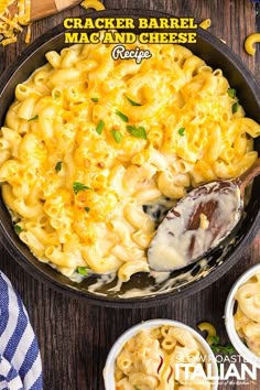 a skillet filled with macaroni and cheese on top of a wooden table