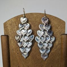 Vintage 1980's Boho Silvertone Cascading Heart Duster Earrings.  Each heart can move freely so makes for a fun and flirty shimmery effect! They might be silver plated, as they did shine up, but no makings. Lightweight and comfortable. Ships from a smoke free pet free environment. Thanks for looking! Vintage Silver Metal Heart Earrings, Vintage Silver Heart Earrings In Metal, Vintage Silver Heart Metal Earrings, Silver Dangle Heart Earrings For Party, Vintage Silver Heart Earrings, Nickel-free Heart Drop Earrings For Party, Vintage Silver Heart Earrings For Valentine's Day, Silver Vintage Heart Earrings For Valentine's Day, Silver Nickel-free Heart Earrings For Party