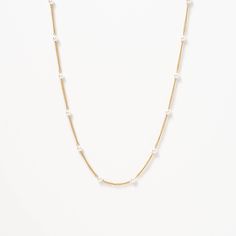 The Satellite Pearl Chain Necklace is a delicate and elegant piece of jewelry that is perfect for any occasion. Featuring a chain adorned with lustrous pearls, it has a minimalist design that exudes sophistication. Wear it alone or layer it with other necklaces to create a unique look that reflects your personal style. Minimalist Pearl Chain Necklace For Layering, Classic White Chain Necklace With Pearl Charm, Minimalist Layering Pearl Chain Necklace, Elegant White Chain Necklace With Delicate Chain, Elegant White Delicate Chain Necklace, White Classic Clavicle Chain Necklace, Classic Layering Pearl Necklace, White Delicate Chain Necklace In Gold Plated, Minimalist White Chain Necklace With Pearl Pendant