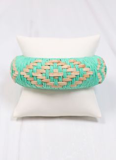 This bangle is so fun! It is wrapped with raffia and is woven with natural patterned accents for a bright look. One size. Bohemian Cuff Bracelet For Spring, Spring Bohemian Cuff Bracelet, Woven Friendship Bracelets For Beach In Summer, Woven Braided Bracelets For Beach In Summer, Summer Beach Woven Friendship Bracelets, Summer Beach Braided Woven Bracelets, Beach Woven Friendship Bracelets, Spring Bohemian Bangle Cuff Bracelet, Summer Vacation Woven Bracelets