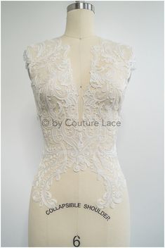 the back of a dress with white lace on it and an inscription that says colossible shoulder