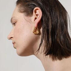 A confident style never goes unnoticed–allow your personality to shine through with these folded triangle hoop earrings, an ode to those who love retro-geometric shapes and artistic creativity. A subversive-basic design blended with wearability gives these hoops endless possibilities.

Size: 24x24mm
Material: 18k Gold Plated On Brass Modern Triangle Gold Hoop Earrings, Trendy Triangle Earrings, Trendy Gold Triangle Earrings, Modern Geometric Single Hoop Earring, Elegant Everyday Triangle Earrings, Modern Single Triangle Earring, Geometric Gold Hoop Earrings For Everyday, Gold Geometric Hoop Earrings For Everyday, Everyday Geometric Gold Hoop Earrings