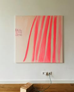 a painting is hanging on the wall next to a wooden box with wires in it