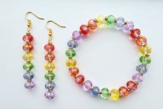 All the colors of the rainbow are represented in this beautiful fairytale-inspired jewelry set! Transparent glass pumpkin beads in bright red, tangerine orange, lemon yellow, apple green, periwinkle blue, and lavender purple are each highlighted with sparkling gold-tone crystal rondelles. Golden flecks decorate the green, yellow and blue pumpkins, adding a magical touch to this festive look! The dangle earrings are approximately 2 inches long, and the stretch bracelet is between 7.5 and 8 inches long for a generous fit. To keep your rainbow pumpkin jewelry from tarnishing, avoid running away from the palace in the rain, and any other damp activities. Multicolor Hypoallergenic Party Jewelry, Multicolor Hypoallergenic Jewelry For Party, Multicolor Czech Glass Jewelry For Party, Multicolor Czech Glass Party Jewelry, Colorful Adjustable Glass Jewelry, Multicolor Faceted Jewelry For Party, Nickel-free Rainbow Jewelry For Party, Rainbow Beaded Glass Jewelry, Rainbow Beaded Round Jewelry