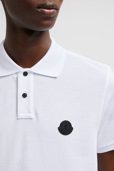 A timeless design that transcends seasons, this polo shirt is crafted from cotton piqué. The classic style is embellished with a Moncler logo patch on the chest. Cotton Polo Shirt With Logo Patch, Casual Cotton Polo Shirt With Logo Patch, Casual Polo Shirt With Logo Patch, Classic Top With Embroidered Logo And Collared Neckline, Classic Top With Collared Neckline And Embroidered Logo, Designer Top With Embroidered Logo And Collared Neckline, Designer Tops With Embroidered Logo, Designer Cotton Tops With Ribbed Collar, Designer White Tops With Ribbed Collar