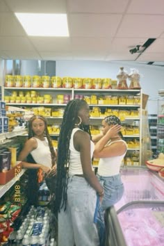 two women standing in front of a grocery store