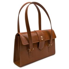 Aida Handbag in Tan/Brown This grand and capacious bag is one of Launer's newer designs. Practical, beautiful, and wonderfully Launer, this piece is an emerging favorite. Suitable for both professional engagements and daywear, this piece is a wonderful, versatile investment. Each of these soft leather handbags is made-to-order, following the exacting standards of the client. The leather is imported from Italy and only butter-soft, unblemished hides are chosen by their leather buyer. Every piece Designer Handheld Business Shoulder Bag, Designer Shoulder Bag With Top Carry Handle For Office, Designer Double Handle Flap Bag For Office, Luxury Handheld Flap Bag For Office, Designer Double Handle Business Shoulder Bag, Timeless Brown Shoulder Bag With Handle Drop, Top Handle Leather Shoulder Bag For Office, Business Shoulder Bag In Calf Leather, Timeless Leather Bag For Work