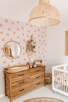 a baby's room with a crib, dresser and mirror