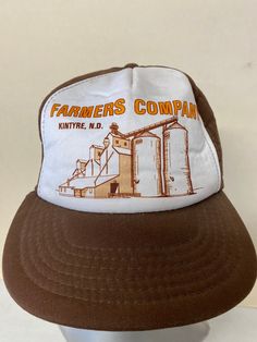 This hat came from a large collection we recently picked up. It looks pretty good and still has some life left. The logo looks nice and the hat likely comes from the late-1980s to the early 1990s. It is adjustable with a Snapback and fits like any modern baseball cap. The hat shows some fading, general wear, and a little staining (please see photos) but still displays well.  SHIPPING INFORMATION: We usually ship in 2-3 days of getting a cleared payment. Tracking is included in our shipping price Retro Fitted Baseball Cap, Retro Dad Hat With Curved Brim, Retro Snapback Cap, Retro Brown Baseball Cap With Short Brim, Retro Baseball Cap With Curved Brim, Retro Snapback Hat With Curved Brim, Vintage Adjustable Trucker Hat With Flat Brim, Retro Flat Brim Hat, One Size Fits Most, Retro Snapback Dad Hat