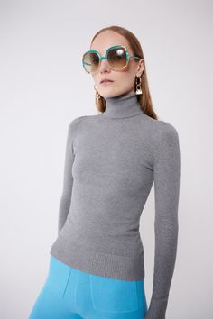 Everyone's staple: a flattering, fitted soft turtleneck. Our signature peachskin classics are instant wardrobe staples. They stand out for their softness, simplicity, and comfort. Not only are they stretchy and perfectly form-fitting, but they also have slight compression properties that feel and look like shape wear. With their carved waist they won't bunch, web, or ride up. The dense and compact peachskin fabrication allows the wearer to go bra-less or layer any color underneath without showin Chic Fitted Fine Knit Turtleneck, Fitted Cashmere Top, Elegant Fine Knit Turtleneck For Spring, Elegant Fitted Fall Turtleneck, Fitted Fine Knit Solid Color Turtleneck, Elegant Stretch Fine Knit Turtleneck, Fitted Fine Knit Turtleneck For Spring, Elegant Solid Spring Turtleneck, Elegant Spring Turtleneck For Layering